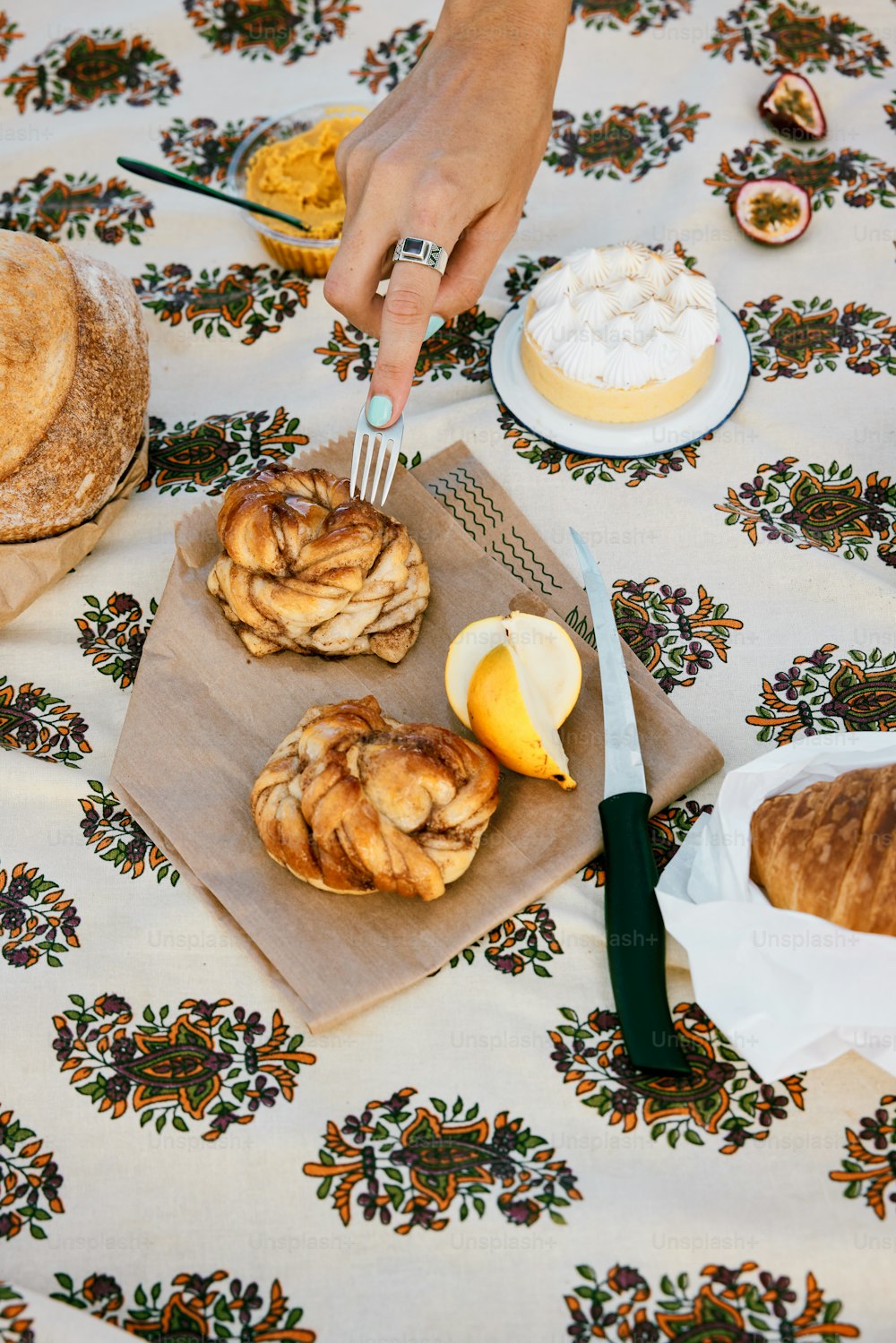 a table topped with pastries and lemon wedges