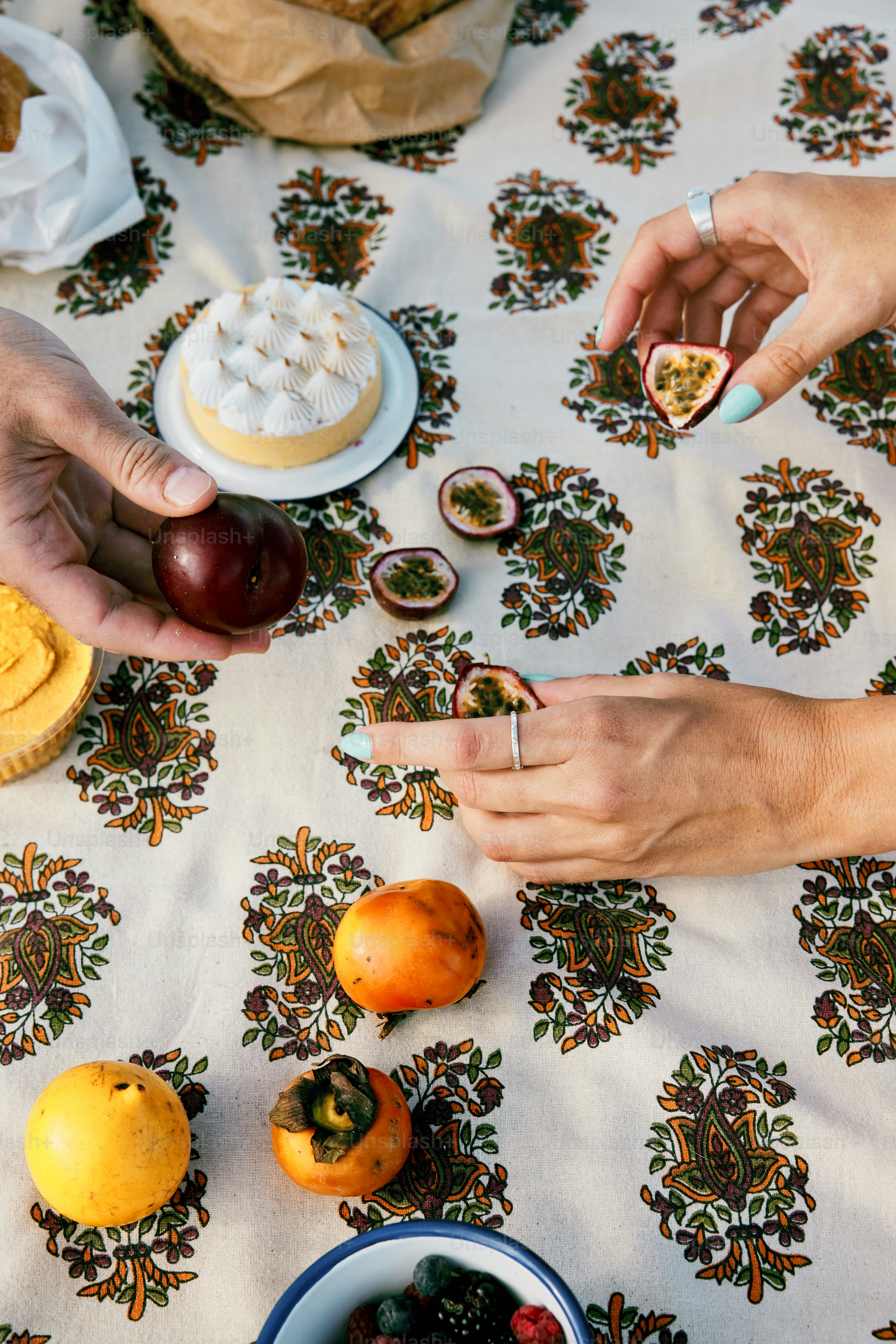a table topped with plates of food and a bowl of fruit