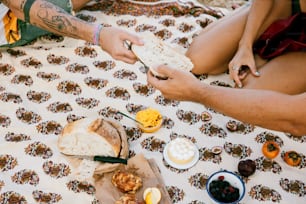 a man and a woman sitting on a table with food