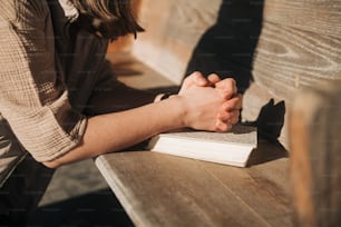 a person sitting on a bench with a book