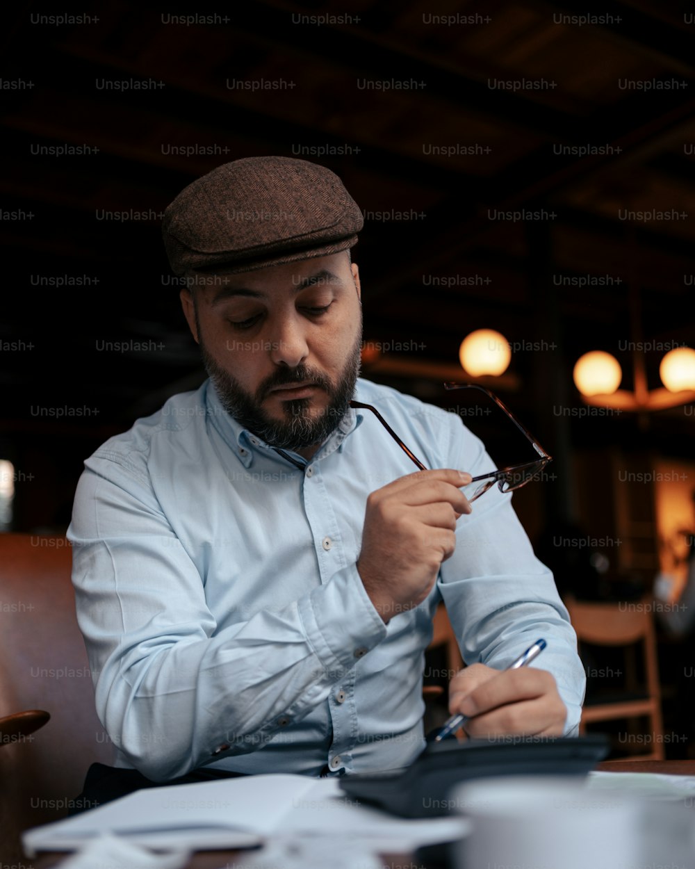 a man sitting at a table reading a book