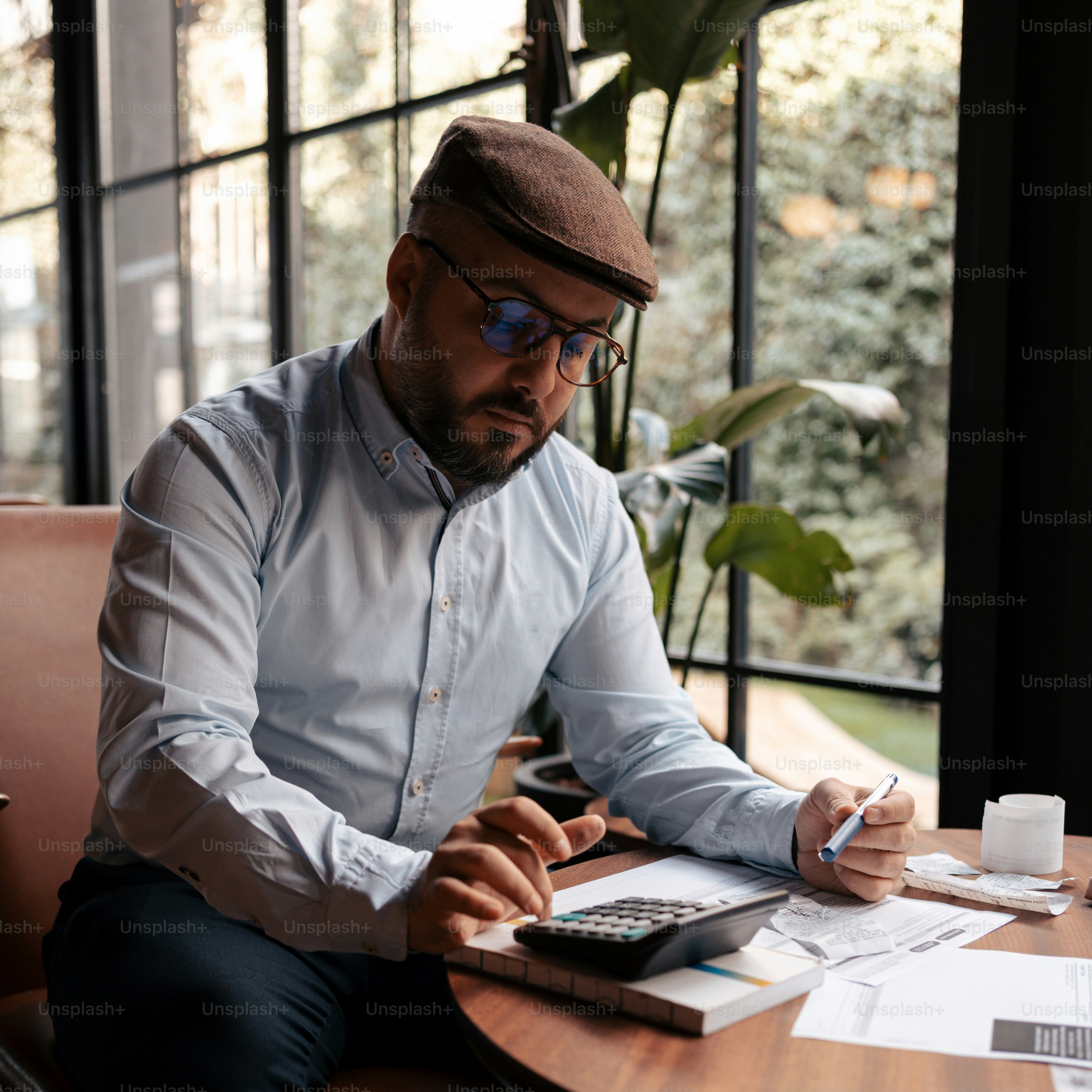 a man sitting at a table with a calculator