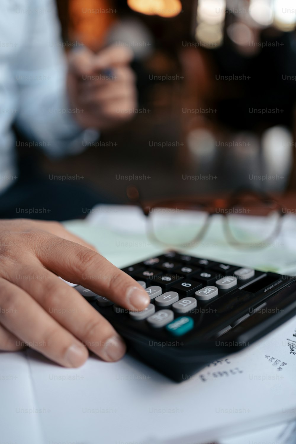 a person using a calculator on a desk