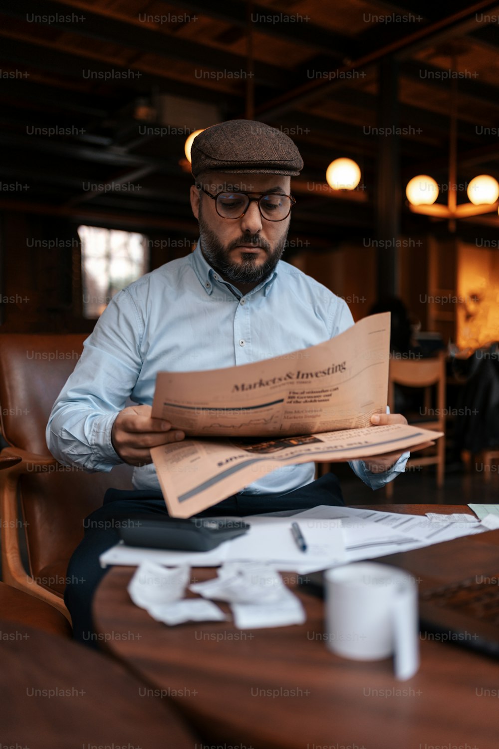 a man sitting at a table reading a book