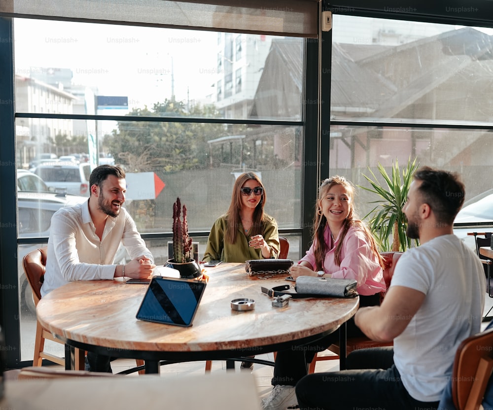 a group of people sitting around a wooden table