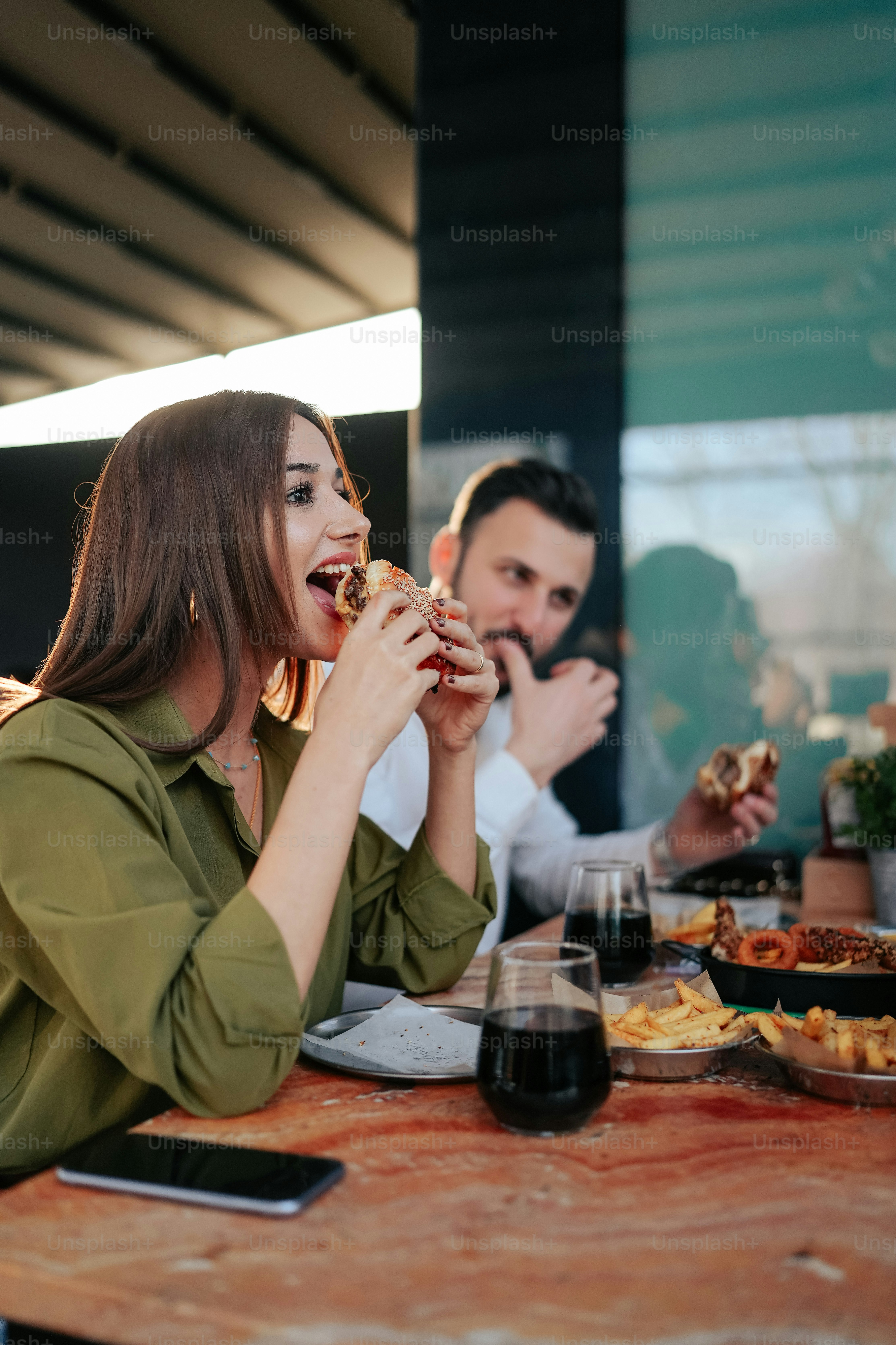 a group of people sitting around a table eating food
