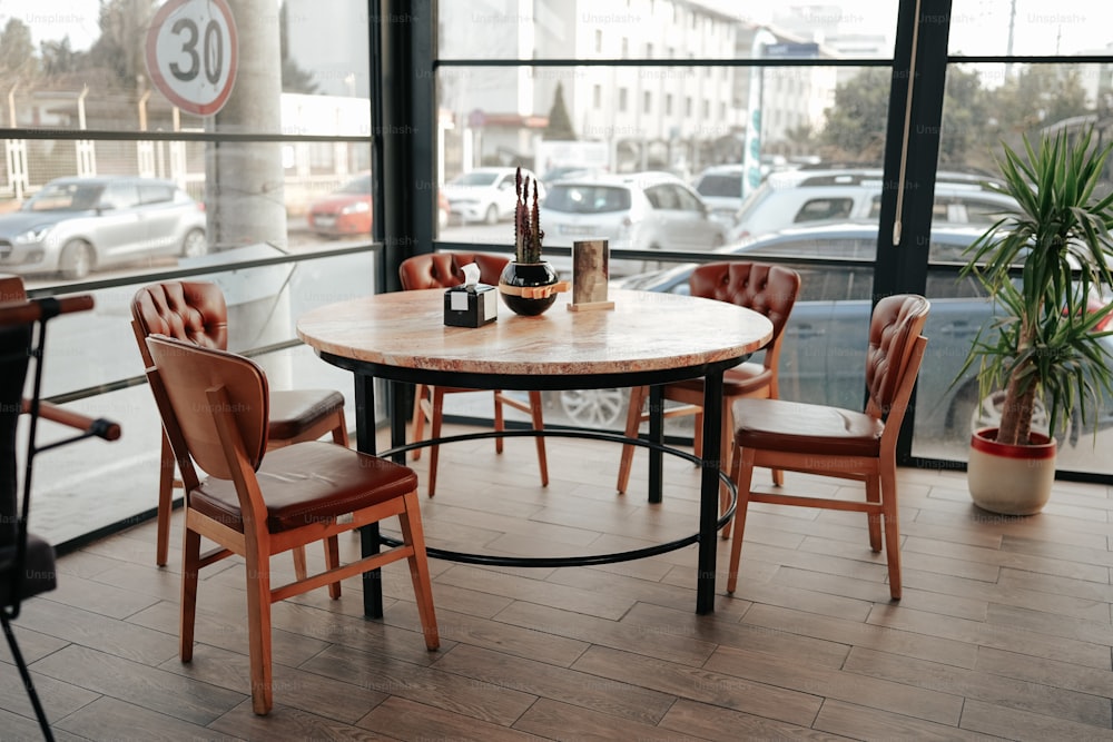 a table and chairs in a room with a large window