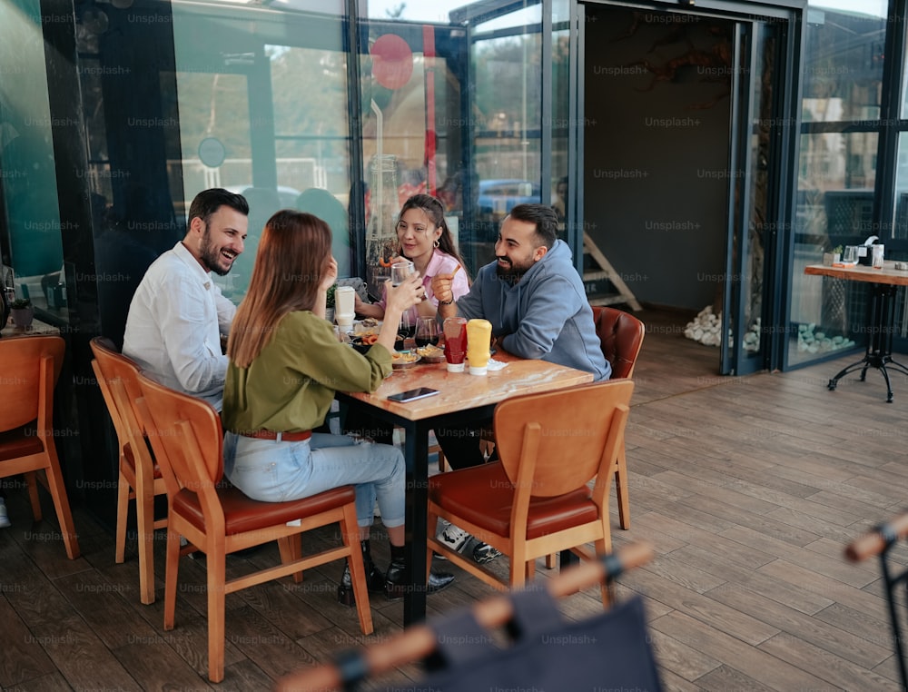 a group of people sitting around a wooden table