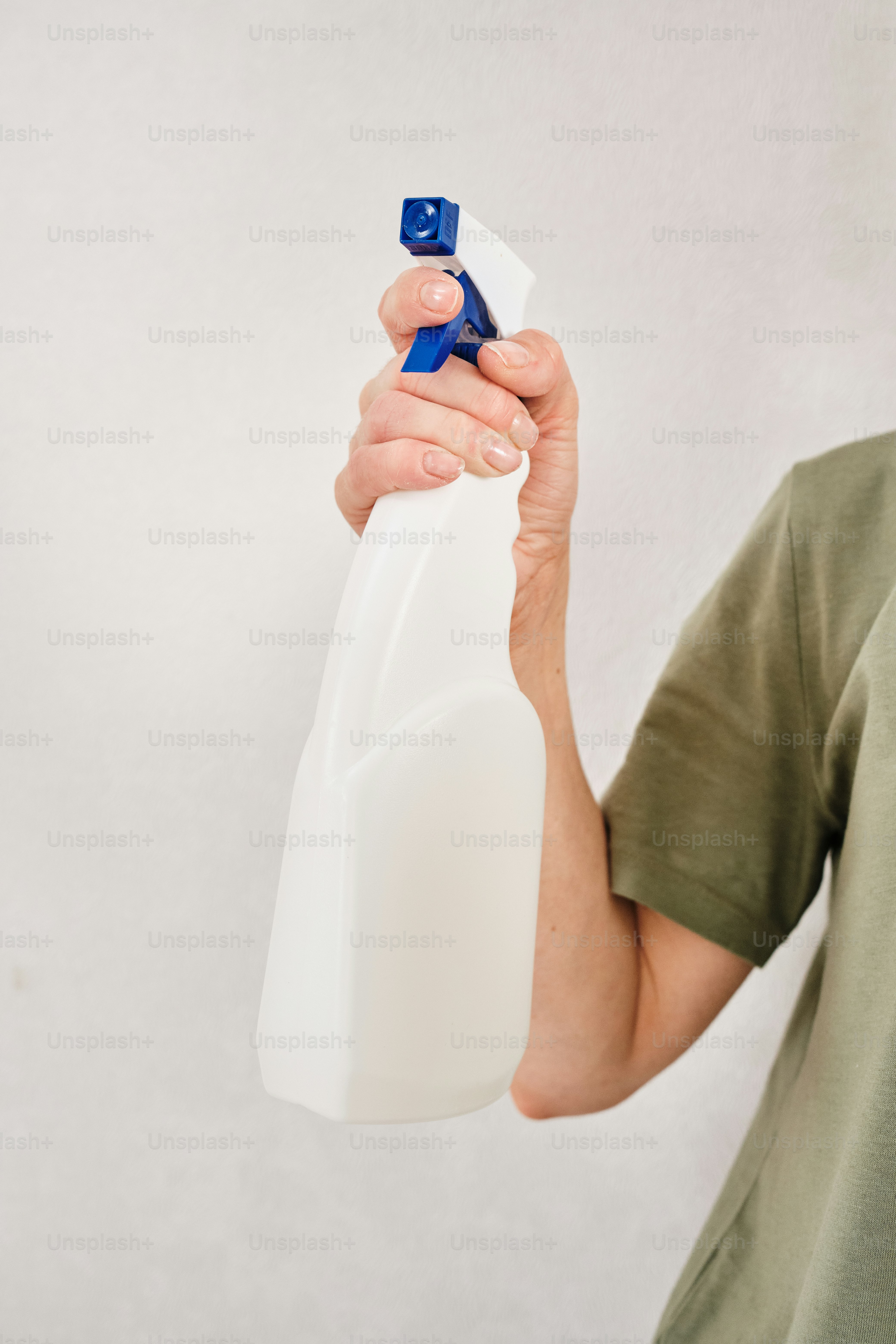 A person holding a plastic bottle with a blue handle photo – Deep ...