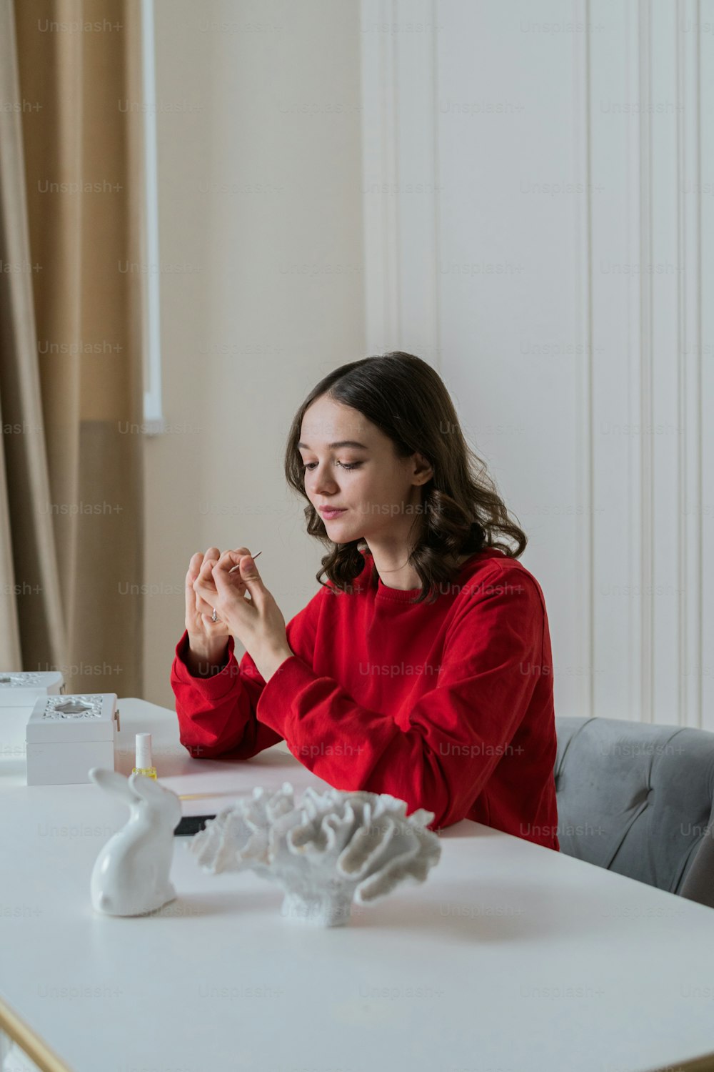 a woman sitting at a table praying