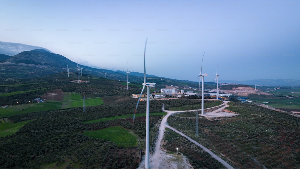 an aerial view of a wind farm with wind turbines