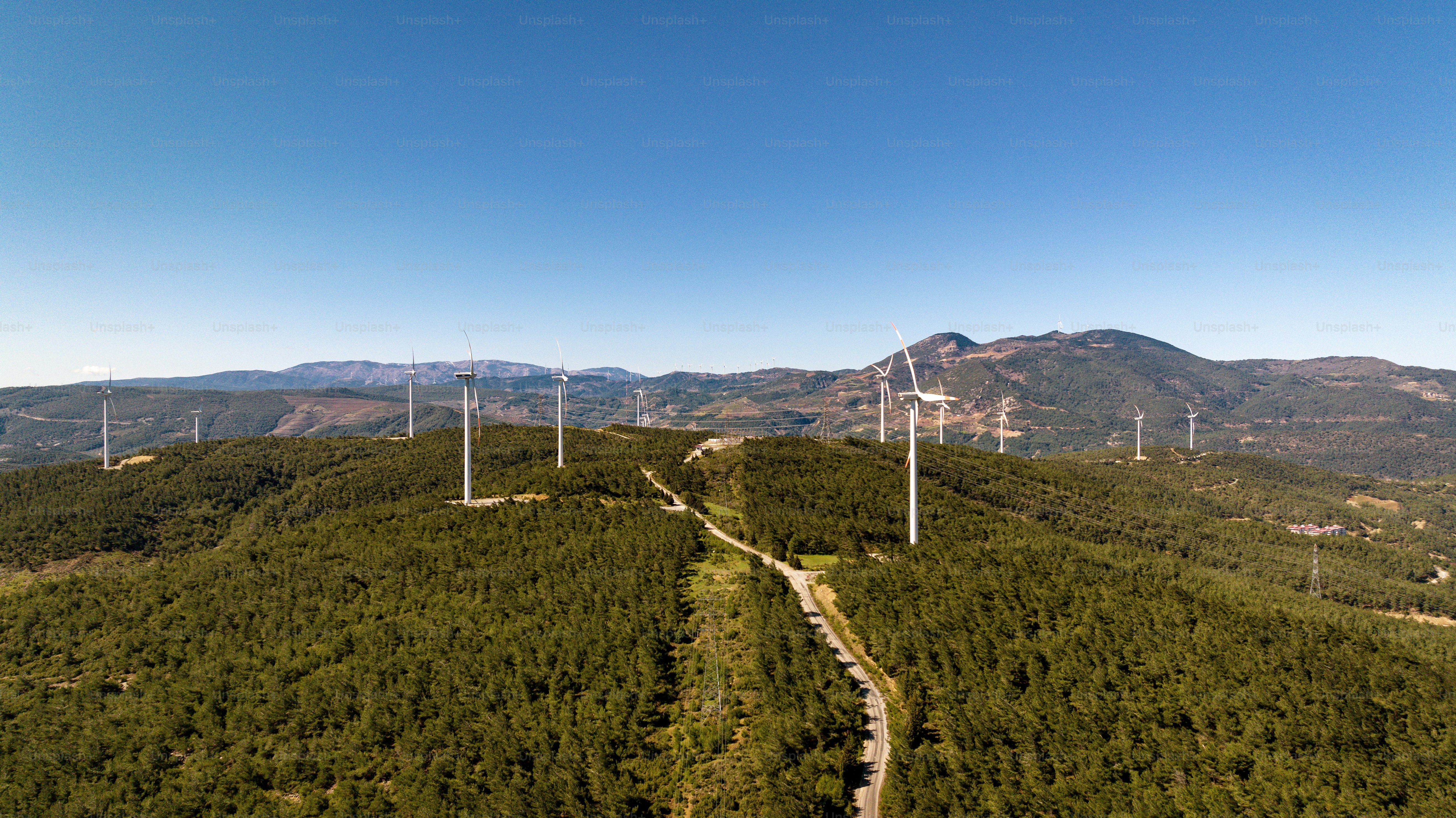 An aerial view of a wind farm in the mountains photo – Renewable energy ...