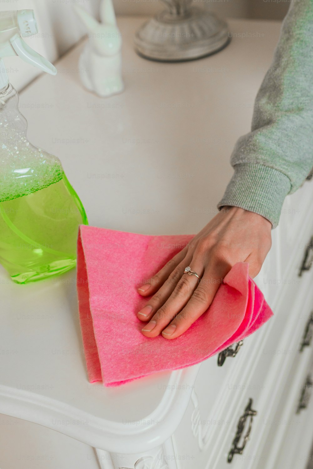 a person cleaning a counter top with a sponge