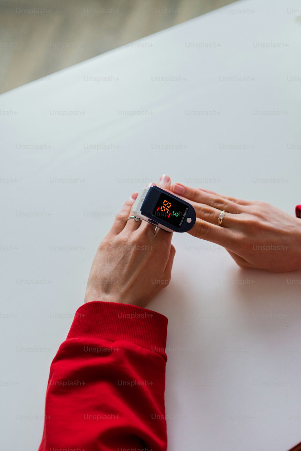 a woman holding a smart watch on her wrist