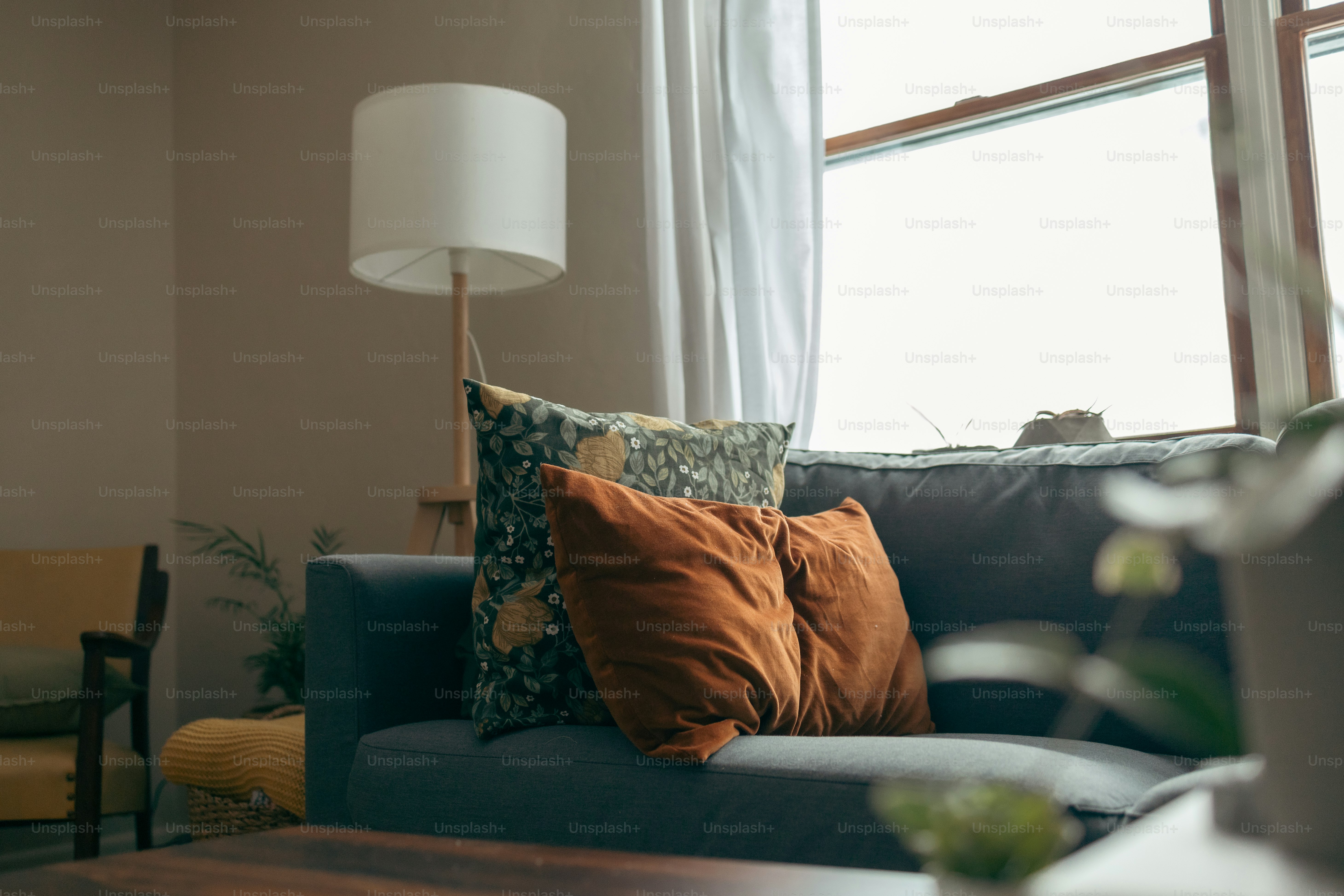 a living room with a couch and a lamp