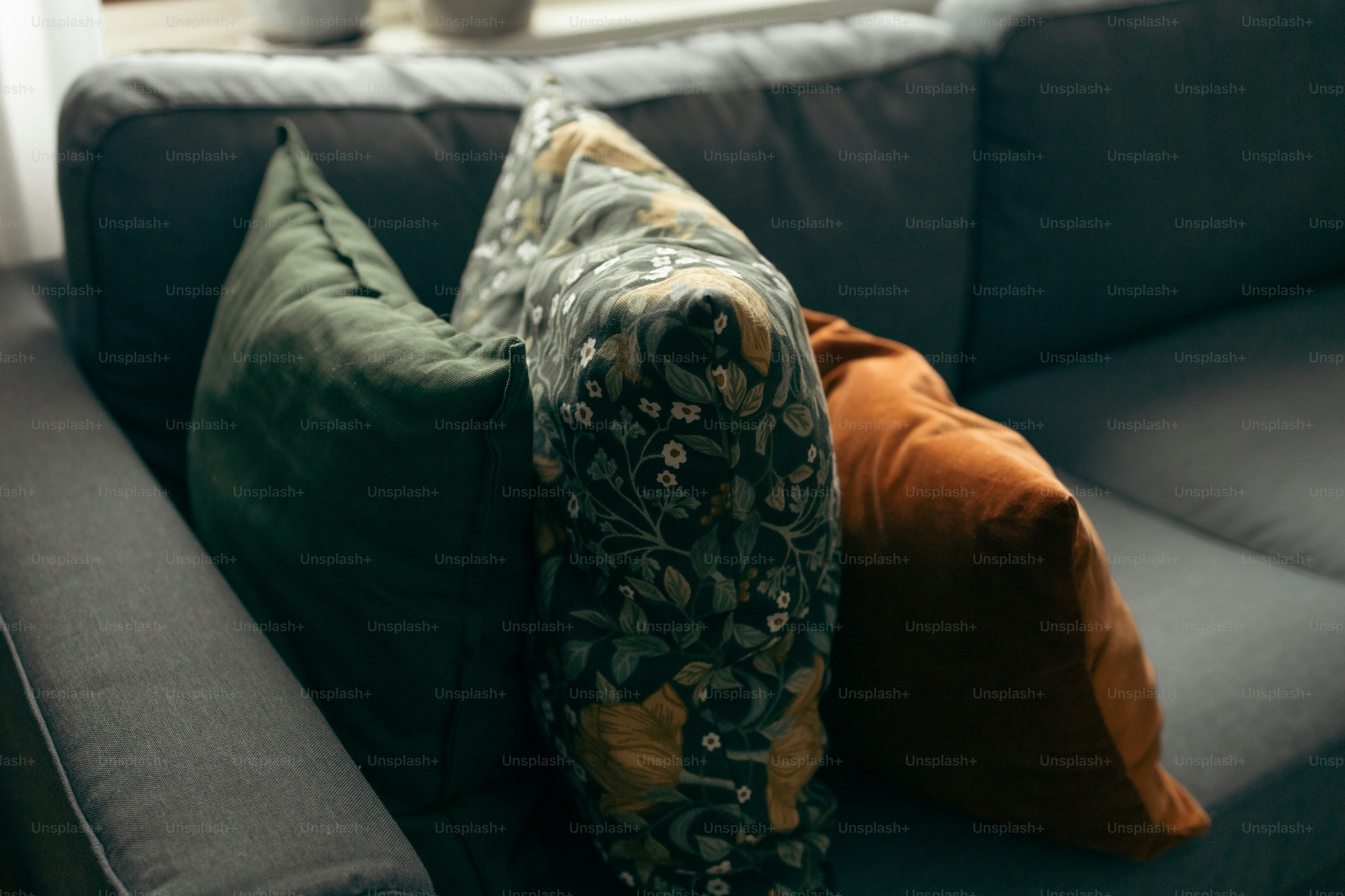 a couch with two pillows sitting on top of it