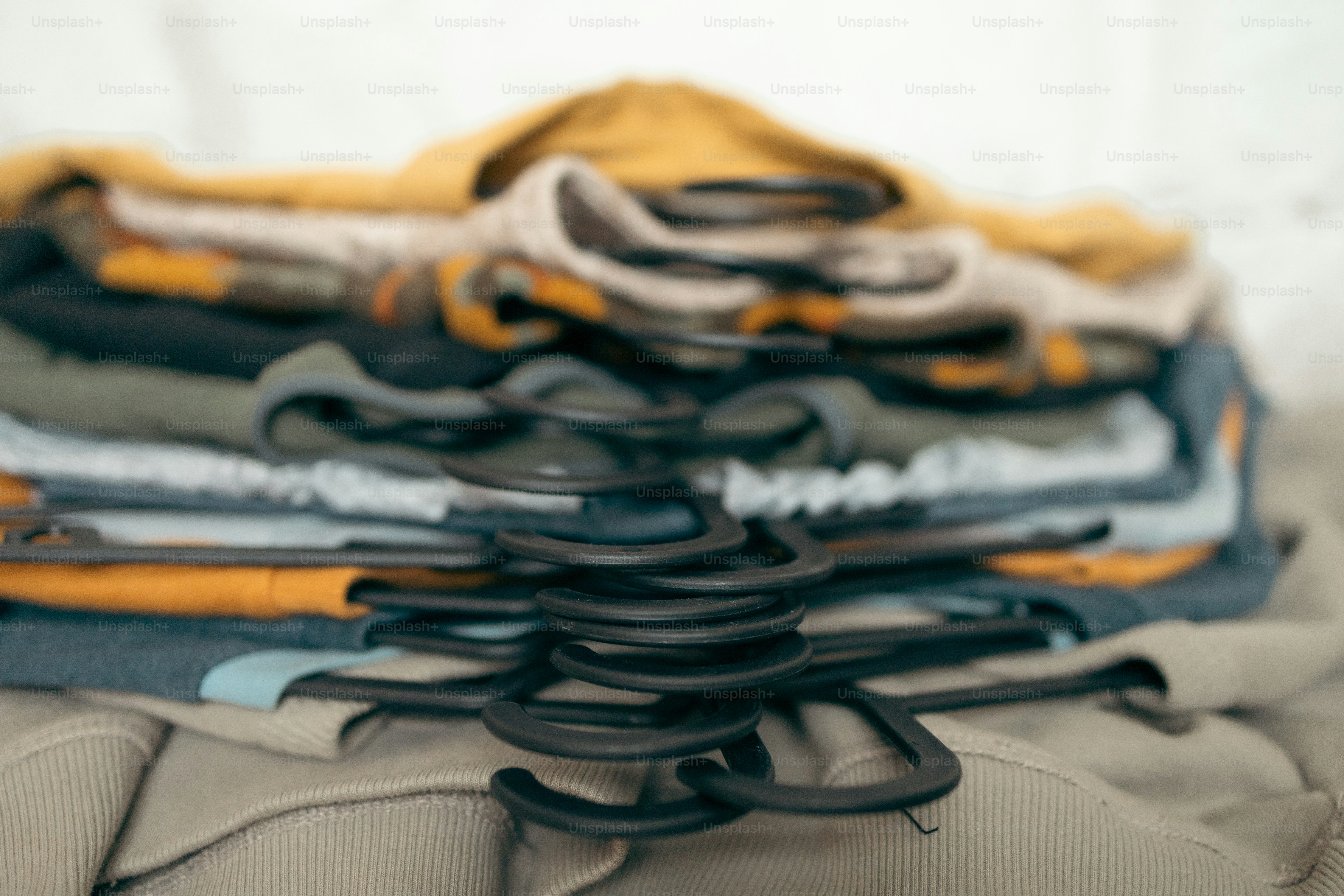 a pile of clothes sitting on top of a bed