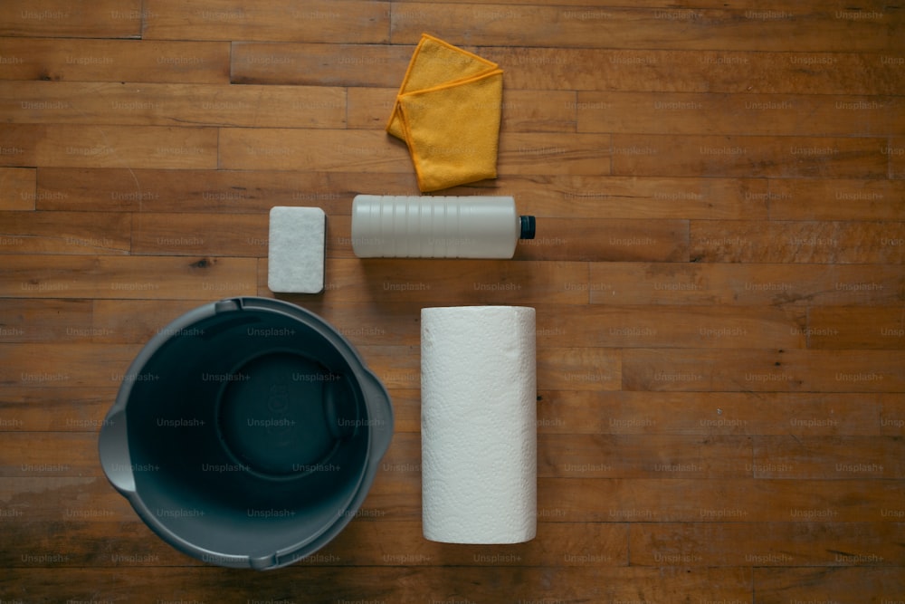 a wooden floor with toilet paper and other items