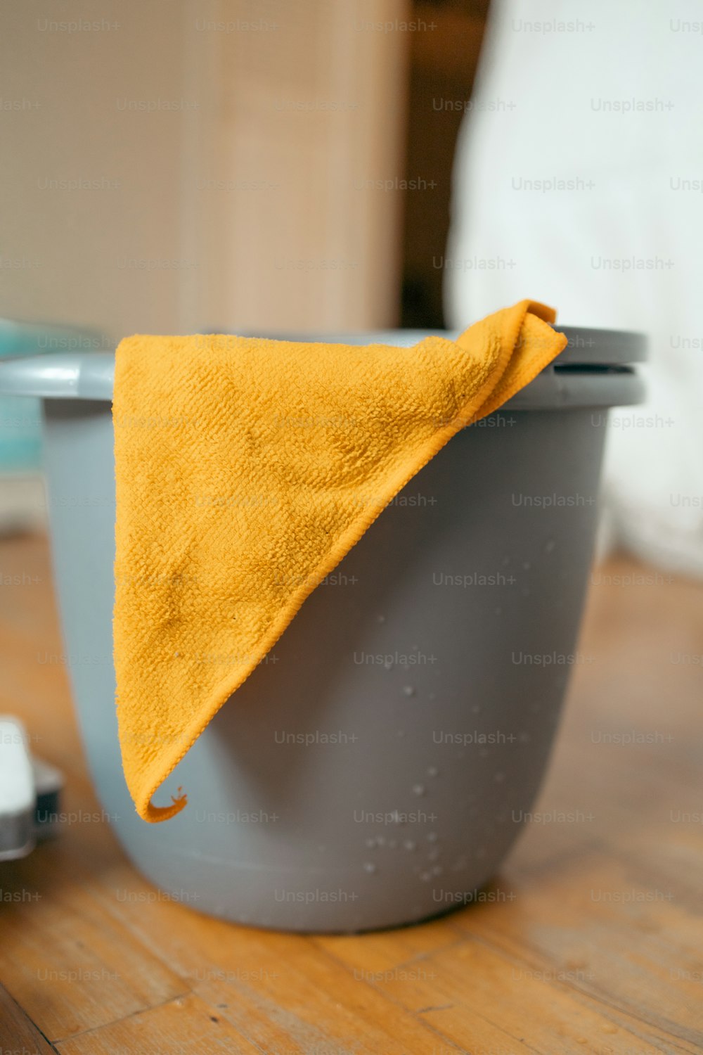a yellow towel sitting on top of a gray bowl