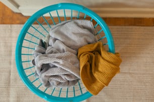 a blue basket with a cloth and a yellow cloth in it