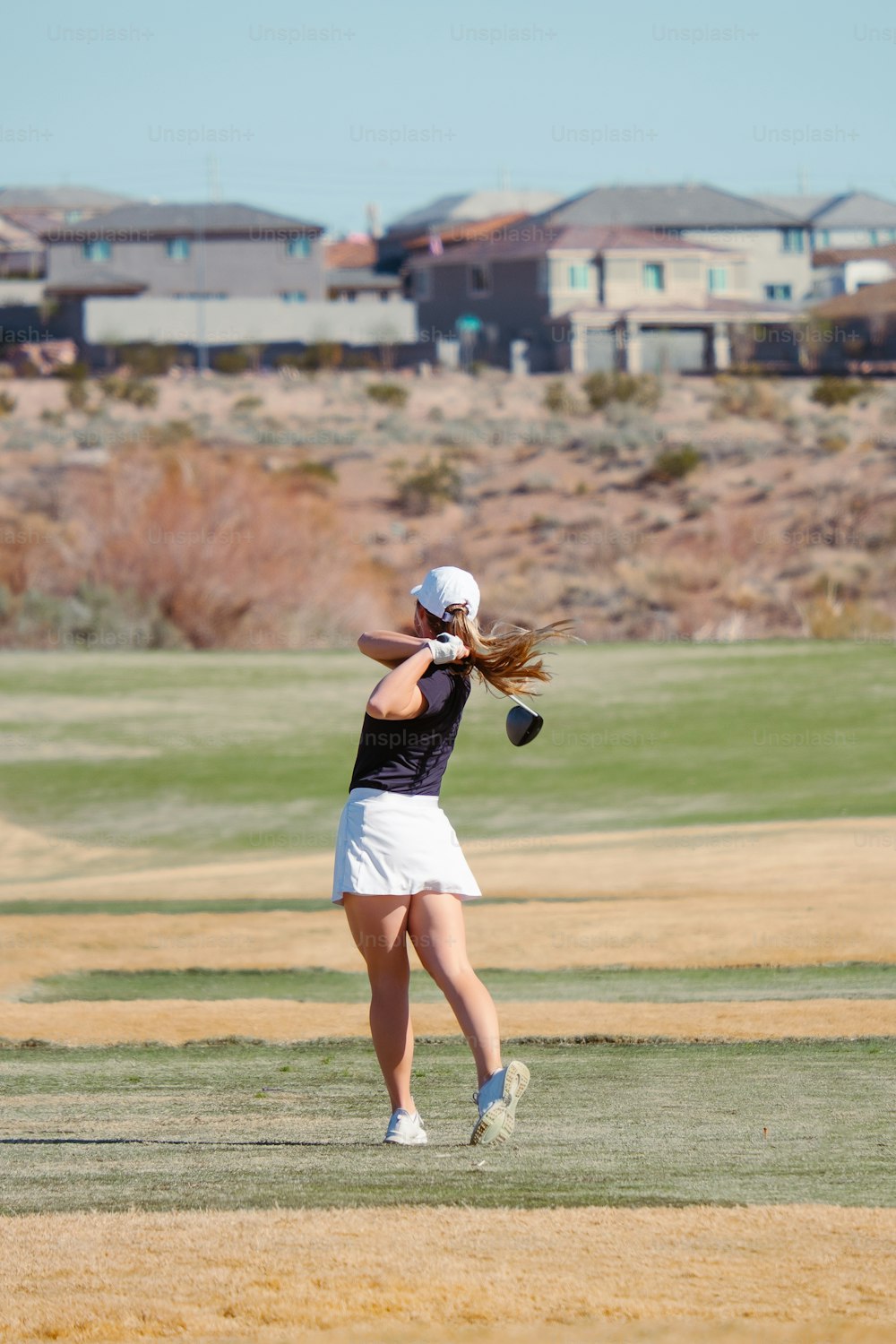 a woman swinging a tennis racquet on top of a field