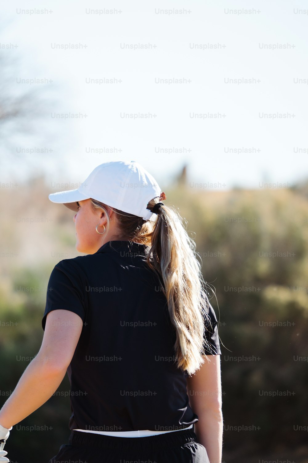 a woman holding a tennis racquet on top of a tennis court