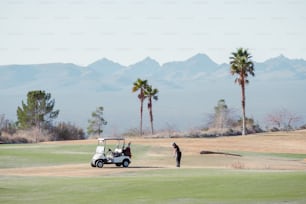 a golf cart and a person on a golf course
