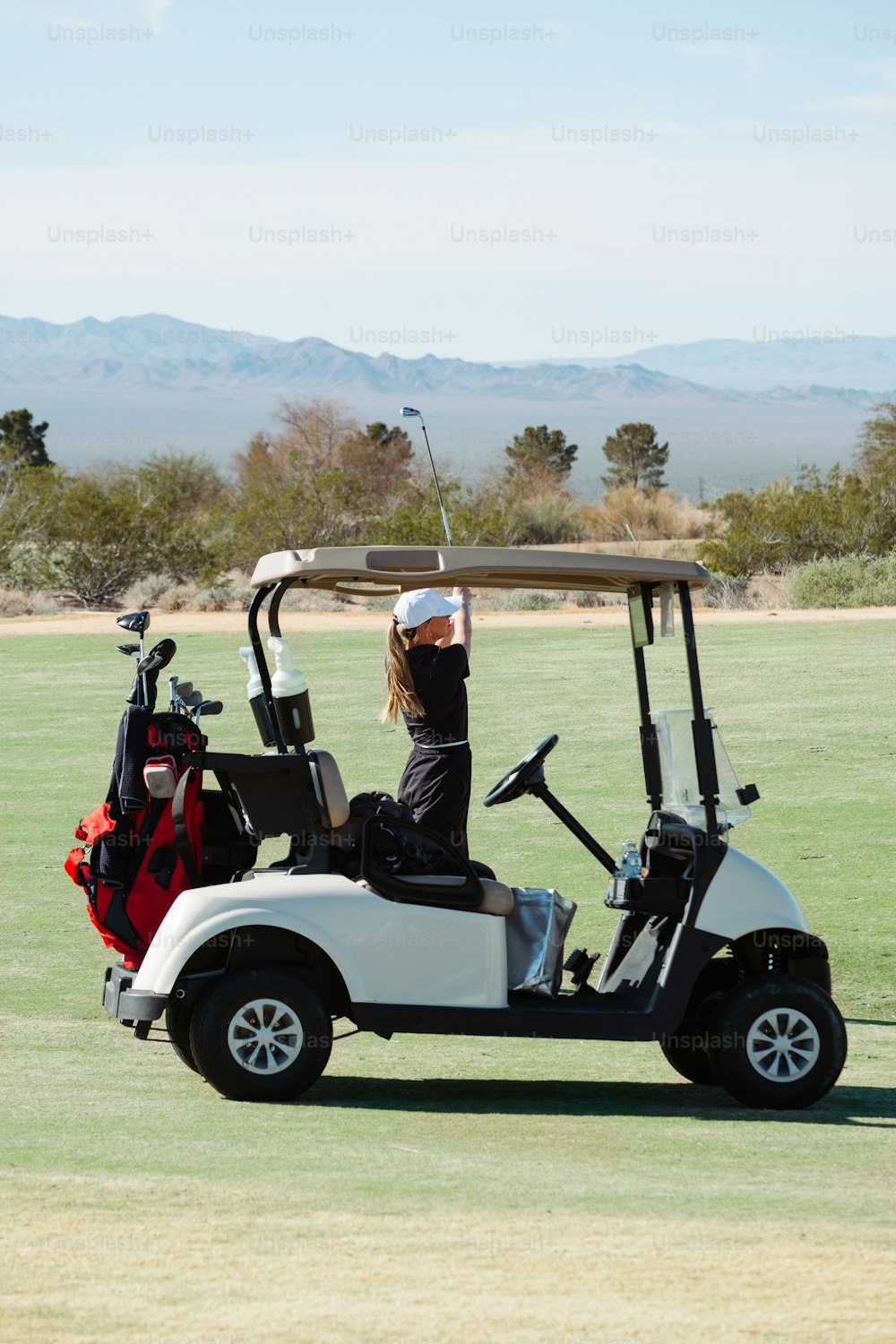 a person on a golf cart with a golf bag