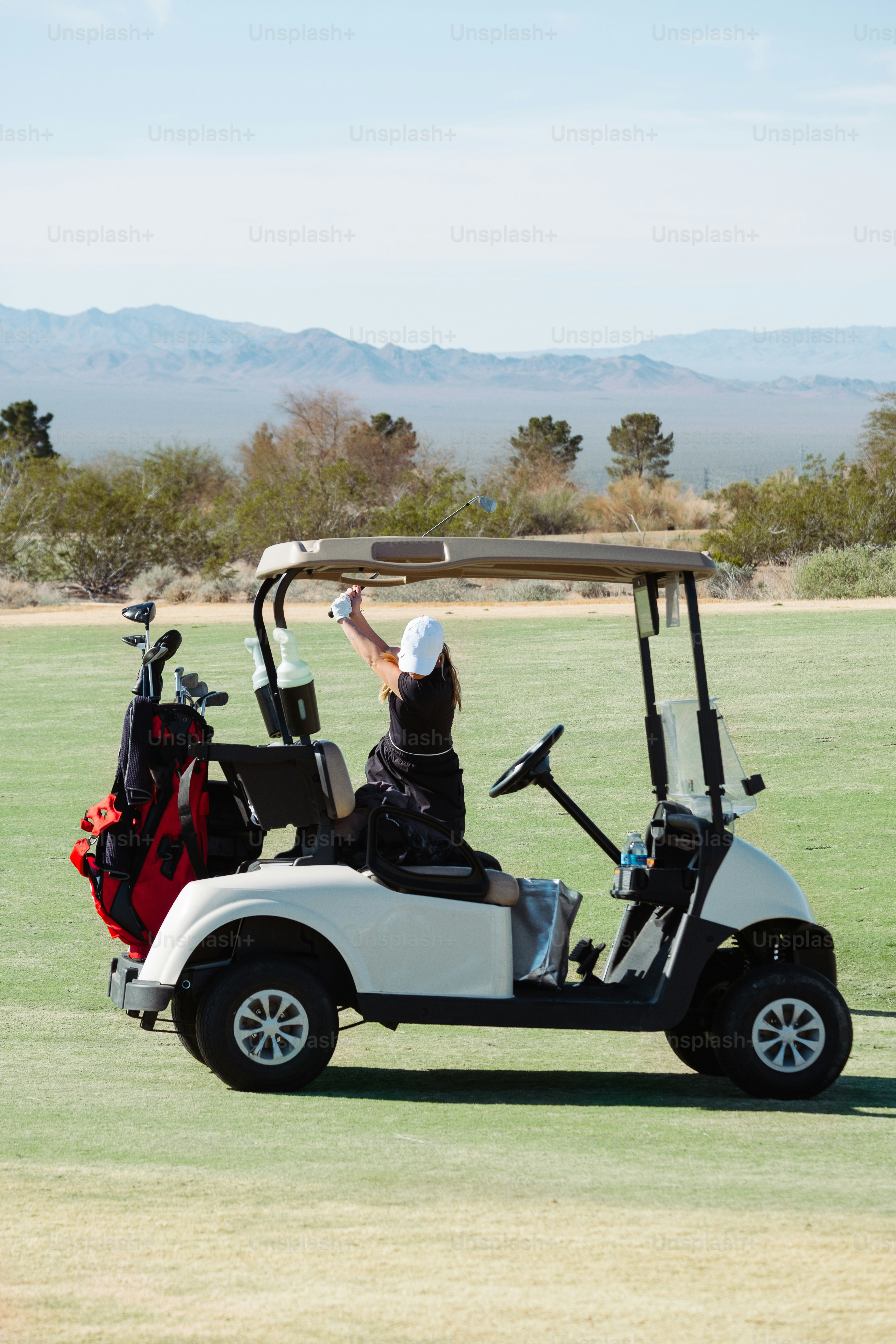 a person riding a golf cart in a field