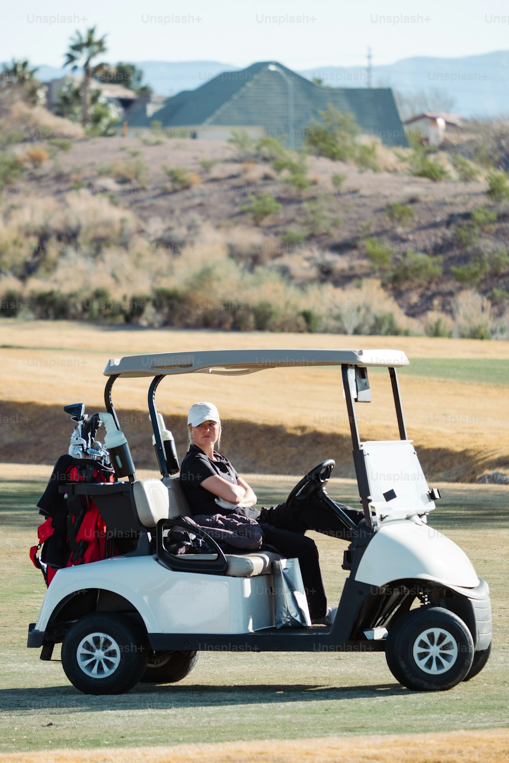 a man sitting in a golf cart on a golf course
