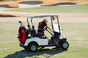 a woman in a black shirt and a white golf cart