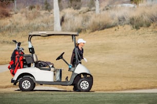 a golf cart with a golf bag on the back of it