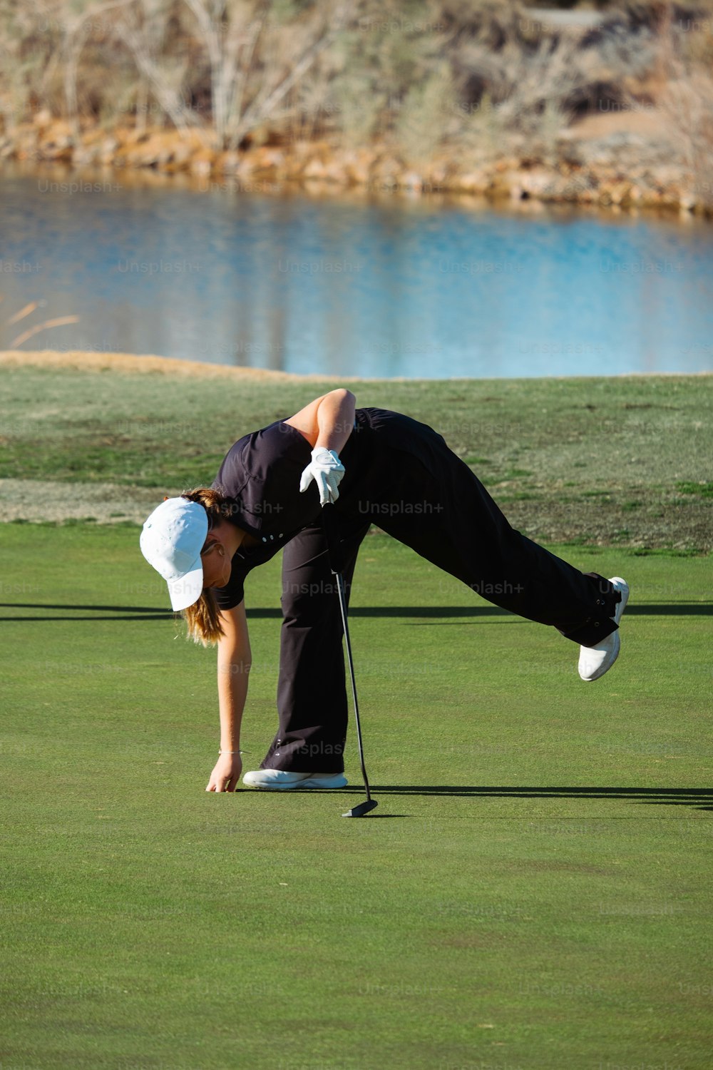 a man and a woman playing golf on a green