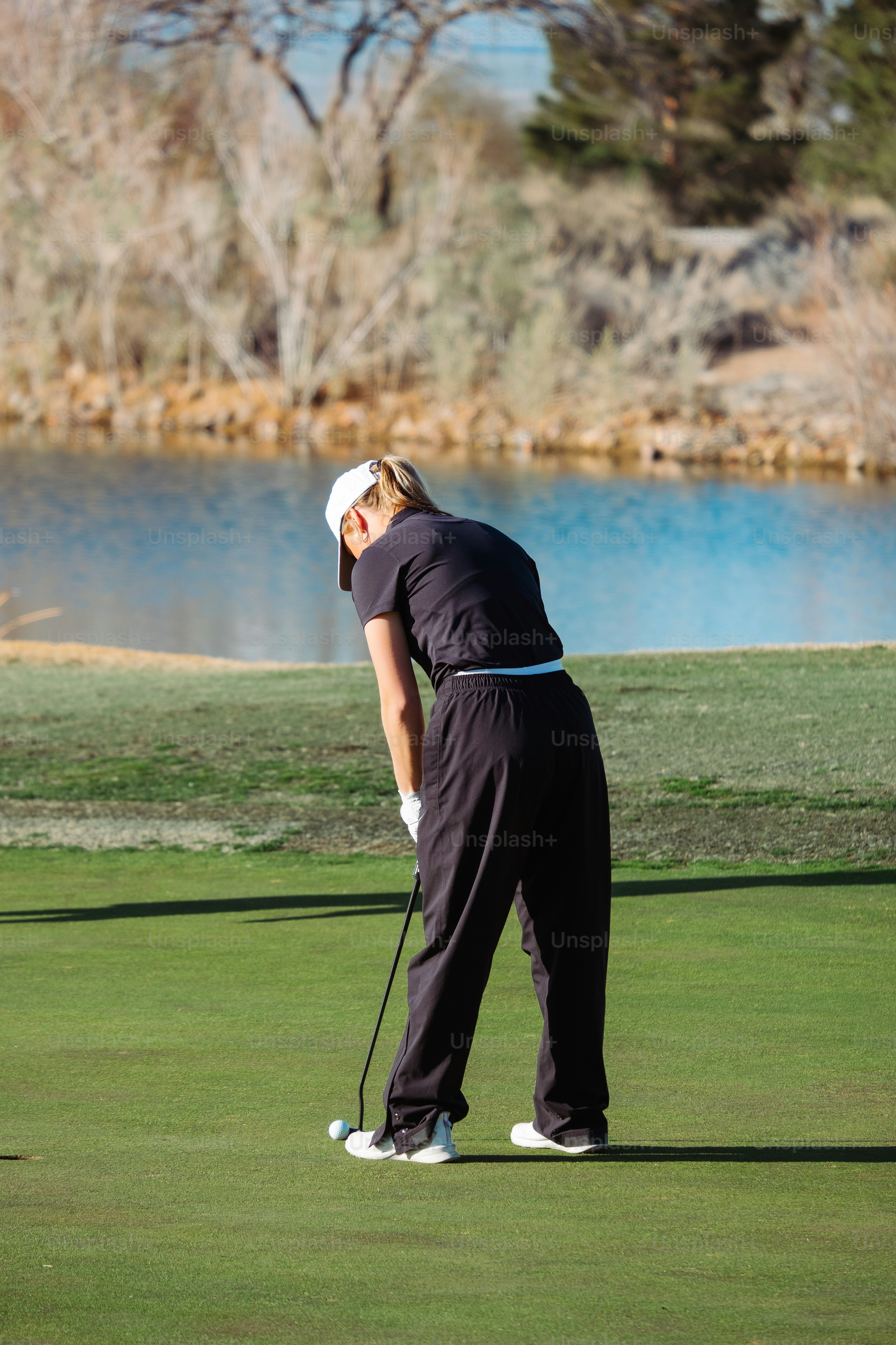 a woman on a golf course holding a golf club