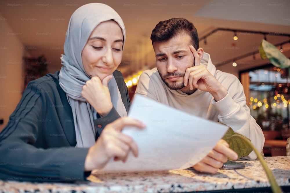 a man and a woman looking at a piece of paper