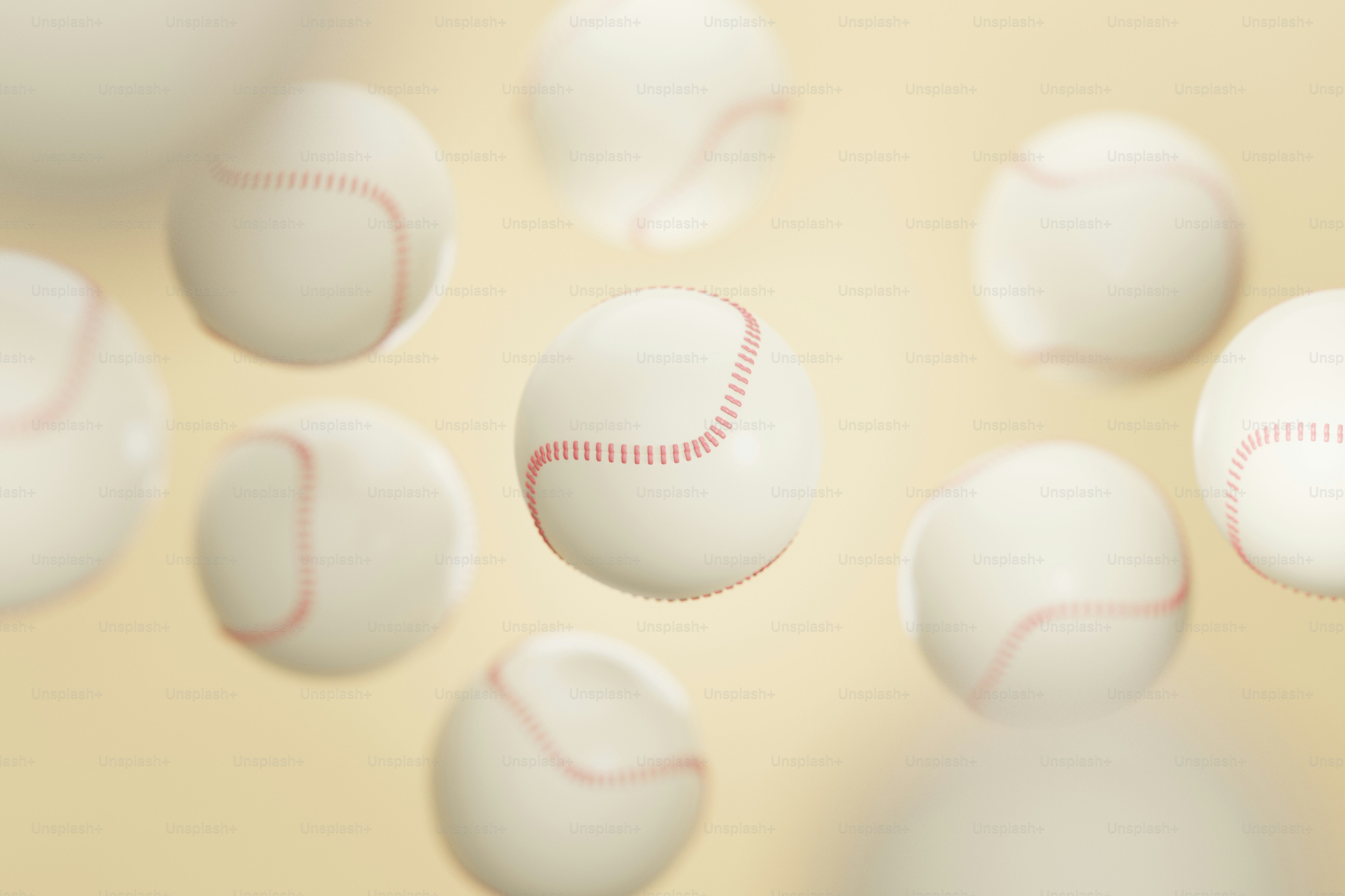 a group of white balls with a red stitch on them