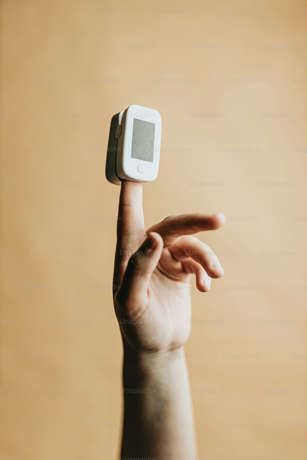 a hand holding a small white object in the air