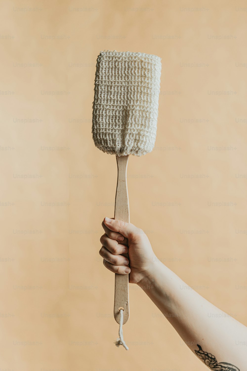 a person holding a white paint brush in their hand