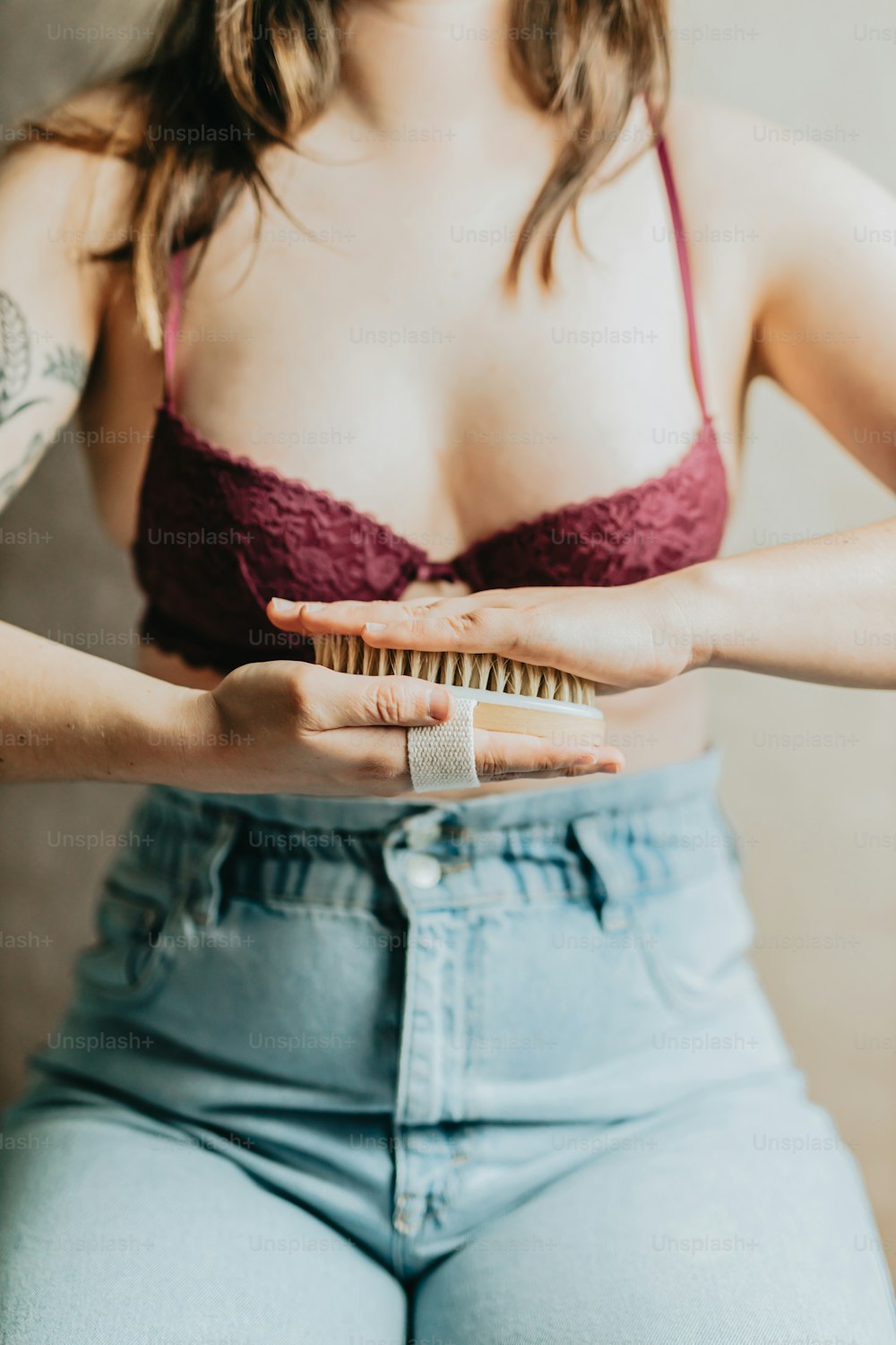 a woman in a bra top is holding a brush