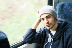 a man sitting on a bus looking out the window