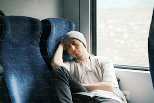 a man sitting on a bus looking out the window