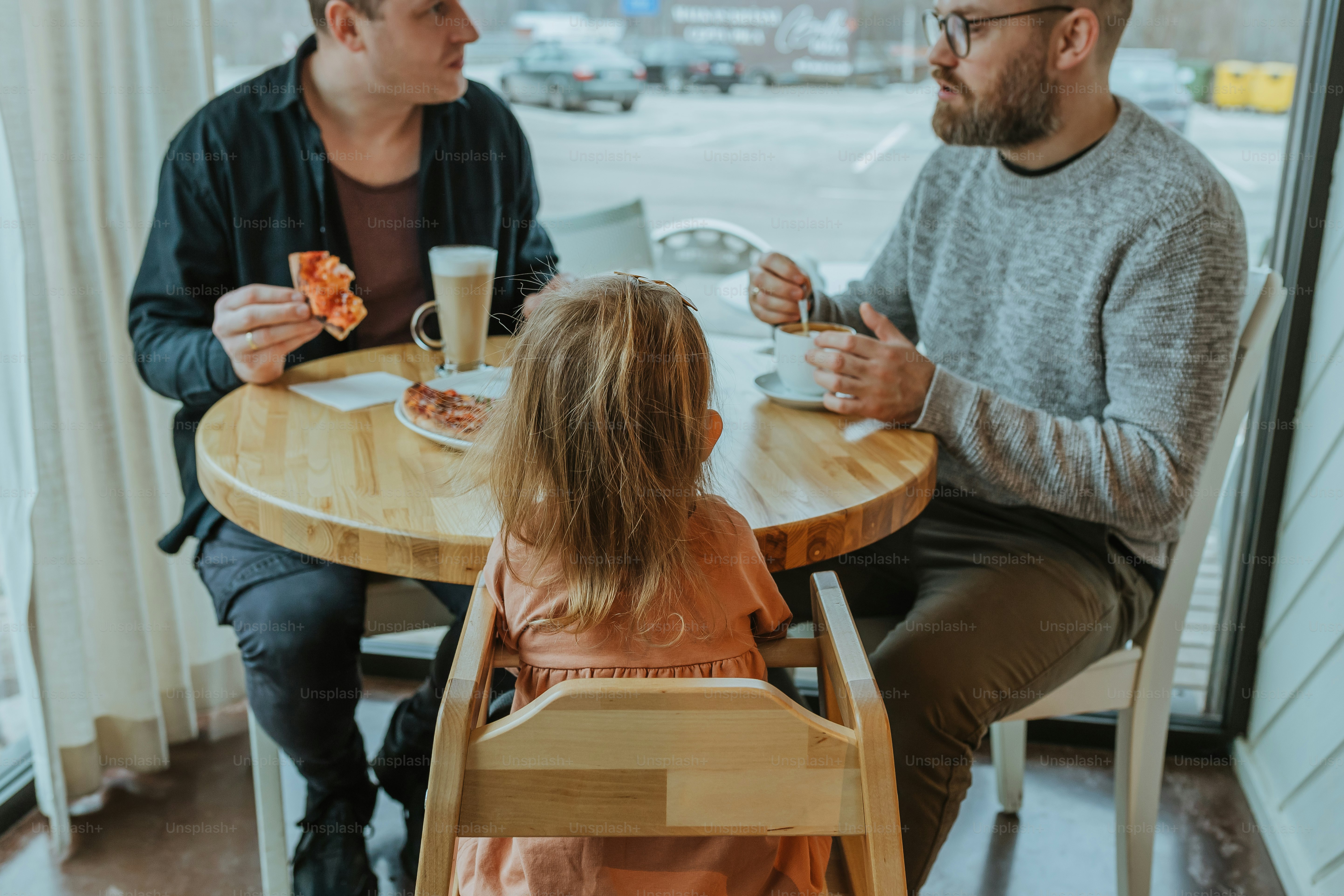 a man sitting at a table with a little girl