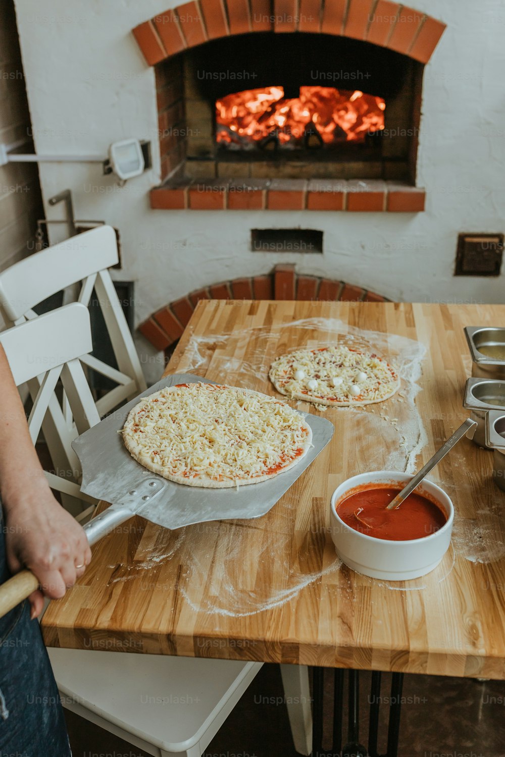 two pizzas sitting on top of a wooden table