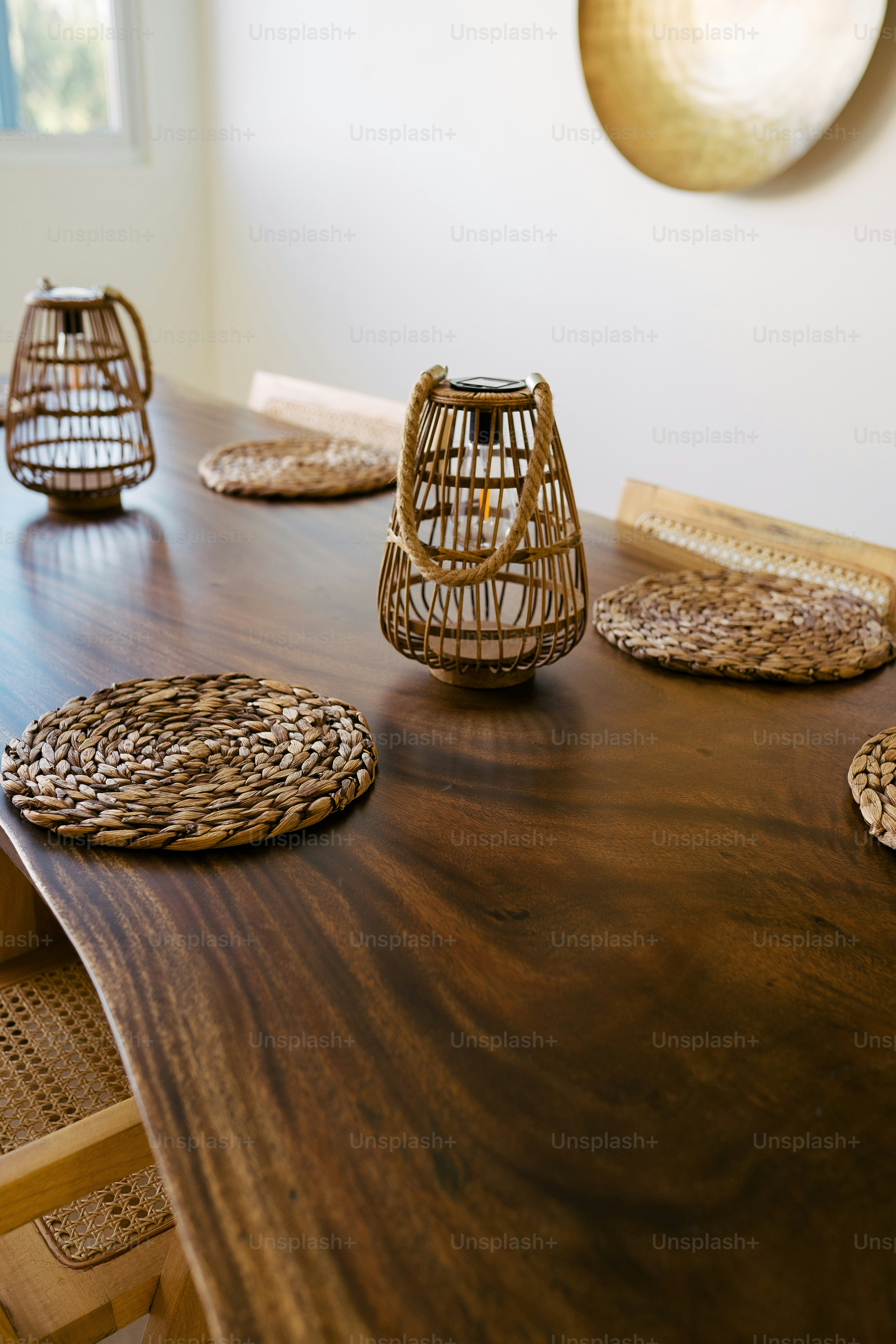 a wooden table topped with wicker place mats