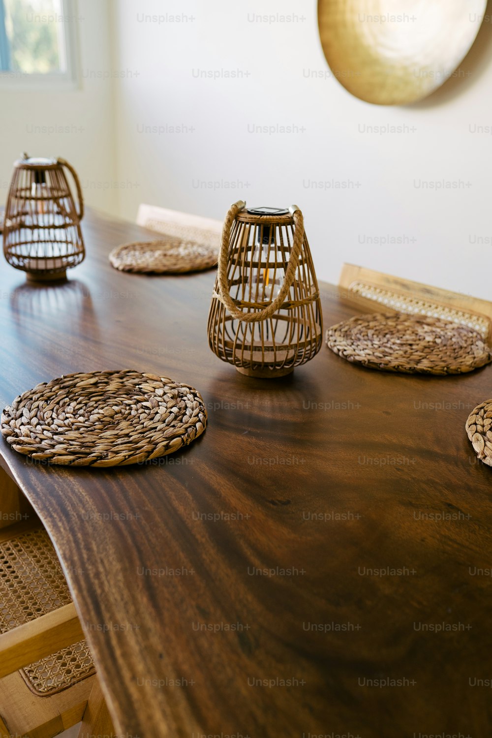 a wooden table topped with wicker place mats