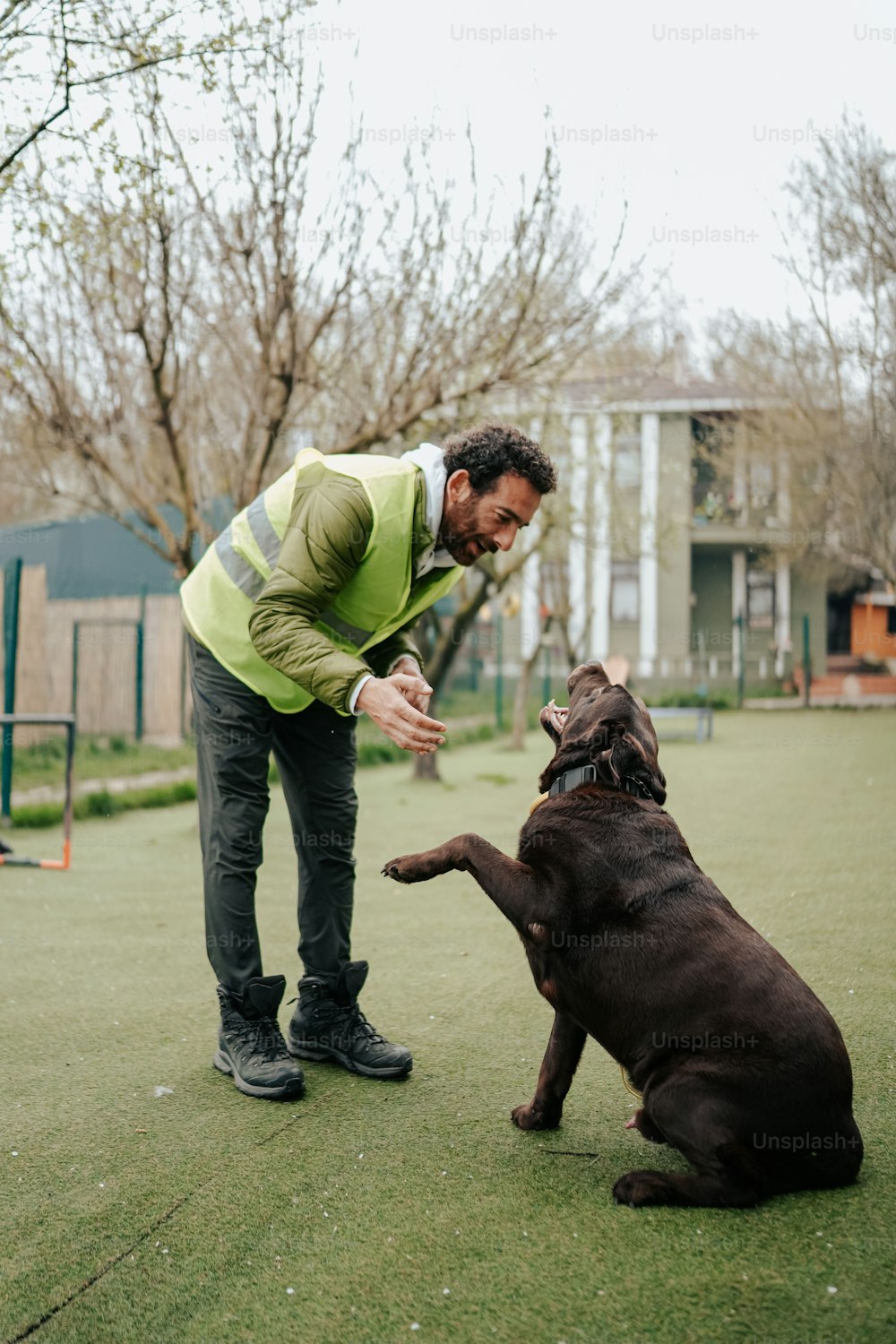 a man playing with a dog in a park