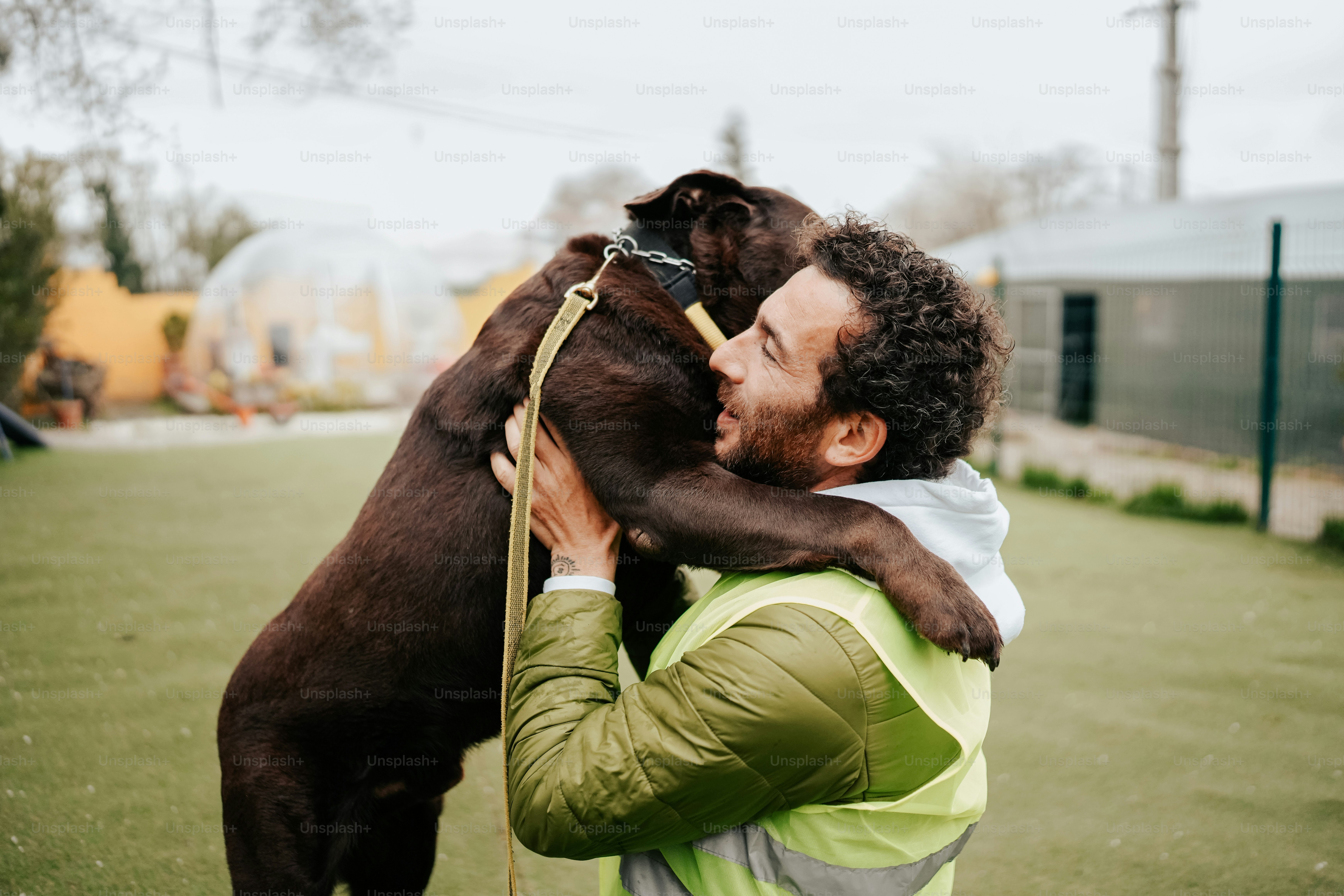 a man holding a dog on a leash