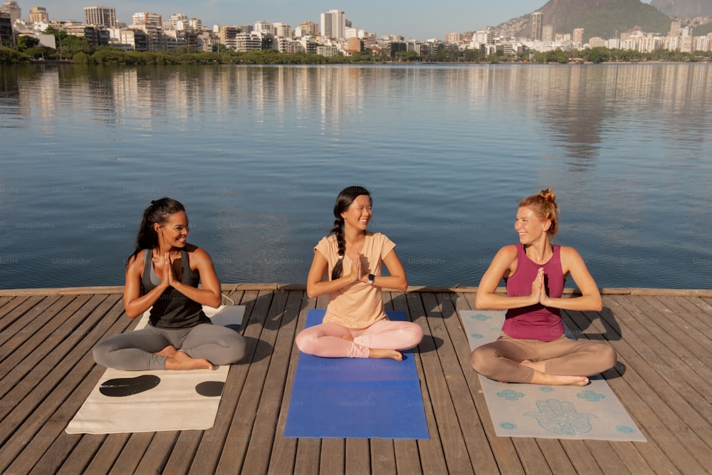 a group of women sitting on top of yoga mats