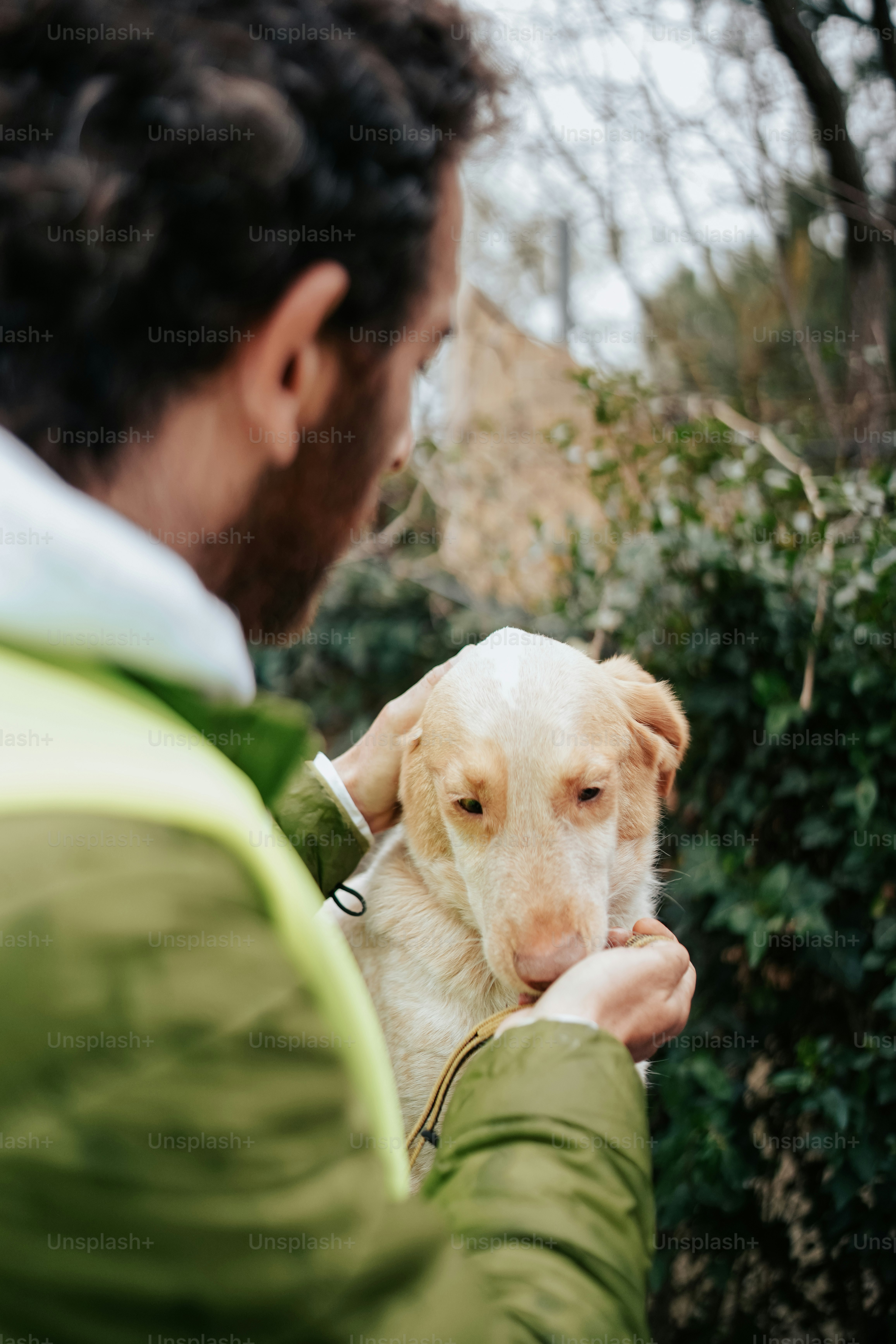 a man holding a white dog in his hands