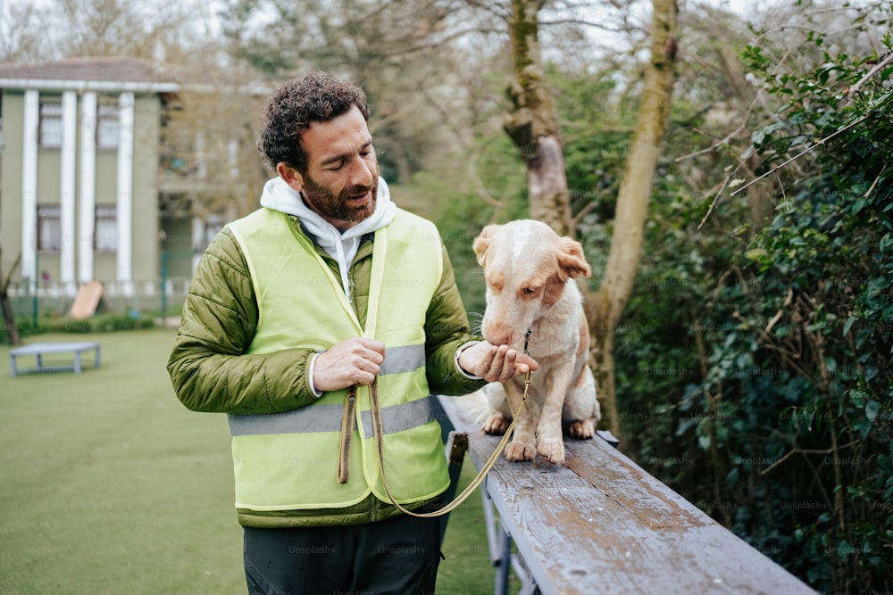 a man is petting a dog on a leash